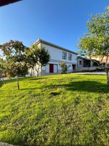 a house with a large yard with trees in front of it at A de Carmiña in A Coruña