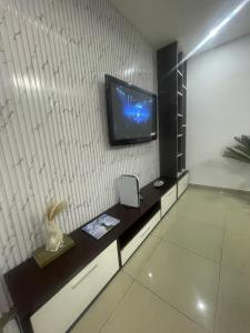 a living room with a tv on a wall at Luxury Ikeja Apartment with 2 Bedrooms in Ikeja +4 photos