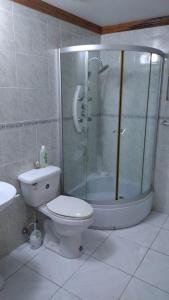 a bathroom with a shower and a toilet and a sink at Sun Valley Retreat in Montego Bay in Montego Bay +16 photos