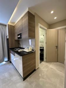 a kitchen with wooden cabinets and a counter top at Chic Apartments For Rent ave0-9 in Amman