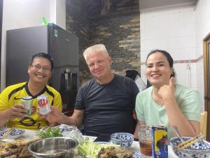 a group of three people sitting at a table at SAM HOUSE in Phan Thiet