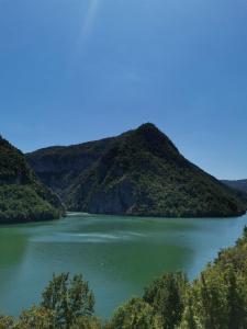 a view of a lake with mountains in the background at Kamp Vodeni Ćiro in Setihovo