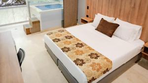 Postel nebo postele na pokoji v ubytování Hotel Madeiro