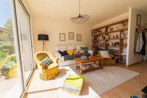 a living room with a couch and a table at La Maison Château d'Eau : piscine pour 6/8 pers in Saint-Benoît