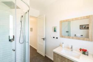 a bathroom with a sink and a mirror at Grace Bay Vacation Villa in Long Bay Hills +9 photos