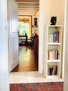 an open door to a living room with a book shelf at Quarto di villa in Granarolo dellʼEmilia +29 photos