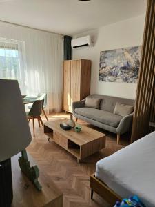 a living room with a couch and a coffee table at D422Apartman in Dunaújváros