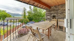 a patio with a table and chairs on a balcony at Derwentwater View in Portinscale