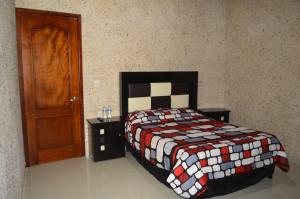 Postel nebo postele na pokoji v ubytování Hotel Guadalupe Bernal