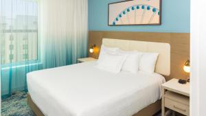 a hotel room with a large bed and a window at Holiday Inn Club Vacations Myrtle Beach Oceanfront in Myrtle Beach