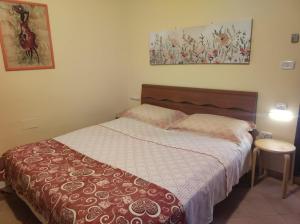 a bedroom with a bed with a red and white blanket at Casa Lucilla in Pizzo