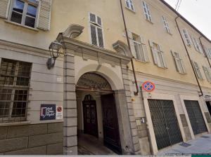 a building with an archway in front of a building at La Casa di Anita in Asti