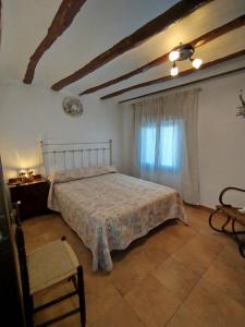 a bedroom with a bed and a window at casa eras irene in Moratalla