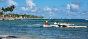 a group of people on jet skis in the water at L'ambre in Deshauteurs