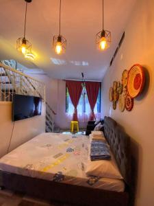 a bedroom with a bed and a tv in it at Aliyah Transient House in Atimonan