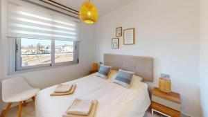 a bedroom with a large bed and a window at Casa Virginia in Los Alcázares +46 photos
