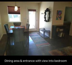 a living room with a dining area and entrance with view into bedroom at River Mountain Getaway-private, large, in- law apt in Jamestown