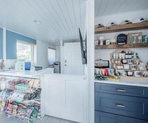 a kitchen with blue and white cabinets and a counter at Blue Wave Suite 9 in Clearwater Beach +1 photo
