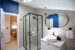 a bathroom with a shower and a sink and a mirror at Regent Blue Apartments in Mostar +76 photos