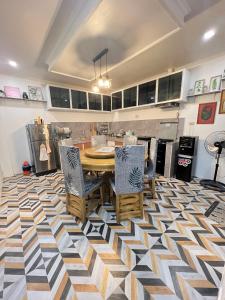 a kitchen with a table and chairs on a checkered floor at Musky in Gray in Ozamis +15 photos