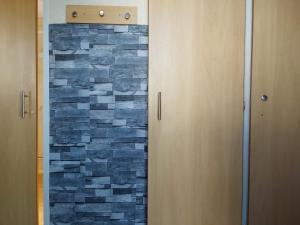 a bathroom with a door with a stone wall at Sunrise Caravan in Dymchurch +83 photos