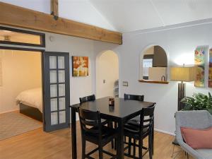a dining room with a table and chairs and a bed at Bluebird Day - River Gem Bungalow in Bend