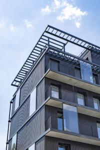 a tall apartment building with a lot of windows at All Suites Appart & Hotel Paris 13 Porte d'Italie in Paris