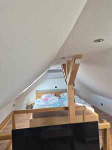 a bedroom with a bunk bed in a attic at Ferienhäuschen Landleben pur in Much