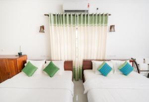 Letto o letti in una camera di The Panorama Negombo