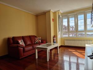 a living room with a couch and a table at Tu hogar, Santoña Home Vibes in Santoña