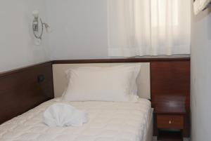 a small bed with a white pillow and a window at Esposizione Boutique in Rome +49 photos