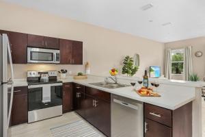 a kitchen with a sink and a stove top oven at Gorgeous Townhome Close to the beaches in Fort Myers