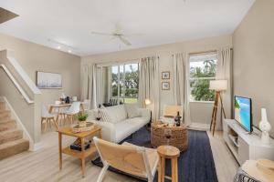 a living room with a couch and a table at Modern Townhouse close to beaches in Fort Myers