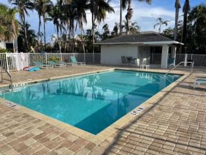 a swimming pool with blue water in front of a house at Paradise at Hidden Palms Cove in Fort Myers
