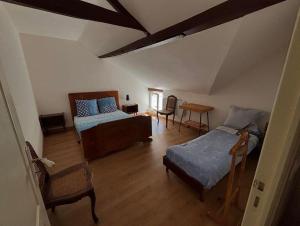 a living room with a bed and a table at Chic et relax in Montmarault