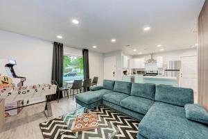 a living room with a blue couch and a table at Cozy Modernized Home - Minutes to Downtown-AUS in Austin