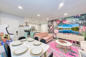 a living room with a table and a couch at Pink Fun Home - Minutes to Downtown-AUS in Austin