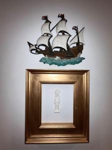 a picture of a pirate ship in a gold picture frame at The Scholar Suite with 1 King in Columbia +2 photos