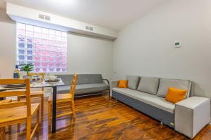 a living room with a couch and a table at Bright 1BR Apt with Niagara Falls and Scenic Stay in Niagara Falls