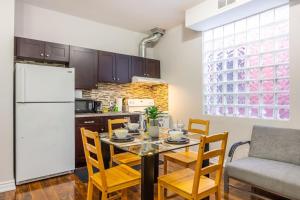 a kitchen with a table with chairs and a refrigerator at Bright 1BR Apt with Niagara Falls and Scenic Stay in Niagara Falls