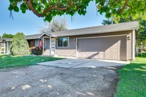 a house with a garage with a flag at Boise Home with Hot Tub, Yard about 5 Mi to Dtwn! in Boise