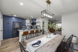 a kitchen and dining room with a table and chairs at Walkable Montrose 2BR Houston Mural Sleeps 9 in Houston