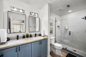 a bathroom with a sink and a toilet and a shower at Walkable Montrose 2BR Houston Mural Sleeps 9 in Houston +23 photos