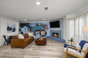 a living room with a couch and a fireplace at Walkable Montrose 2BR Houston Mural Sleeps 9 in Houston