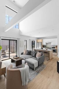 a large living room with a couch and a kitchen at Luxury Penthouse with 2 Floors Pool Patio Gym Walk to Broadway in Nashville