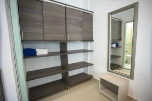 a bathroom with wooden shelves and a mirror at Hotel Poblado Coveñas in Coveñas +56 photos
