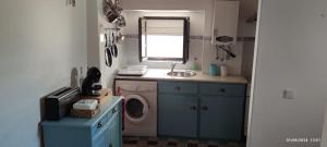 a laundry room with a washing machine and a sink at Casa do Outeirinho in Castelo de Vide +8 photos