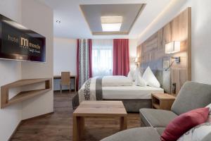 Ένα ή περισσότερα κρεβάτια σε δωμάτιο στο Hotel Mondin