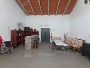 a living room with a table and chairs at Cortijo El Pajaroto in Matanegra