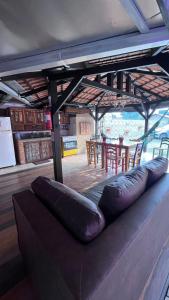 a large couch sitting in a room with a table at Pousada Pier 123 in Penha